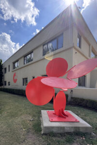 Exterior of the Arts Council of Oklahoma City headquarters featuring a brightly painted sculpture of discs touching on multiple axes.