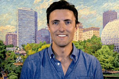 Director of Communications in front of Arts Council OKC Painting of Myriad Gardens.