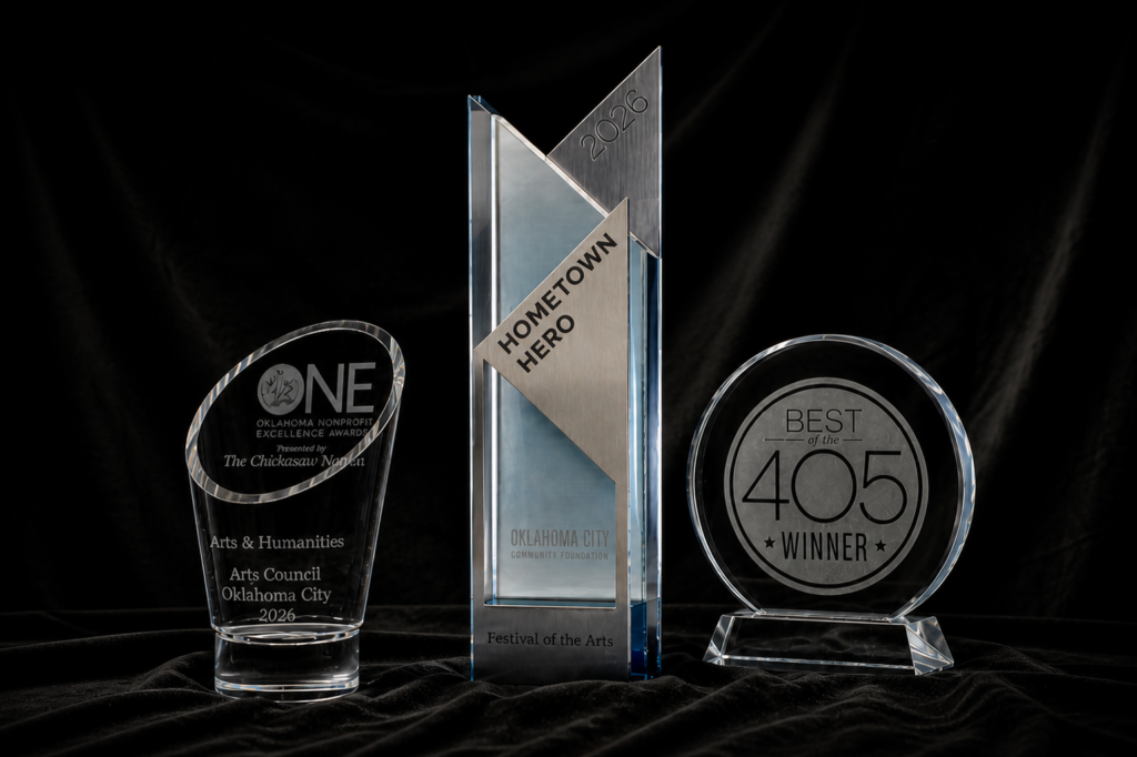 Three translucent awards on a black background: ONE non-profit excellence award, Hometown Heroes award, and Best of the 405 award.