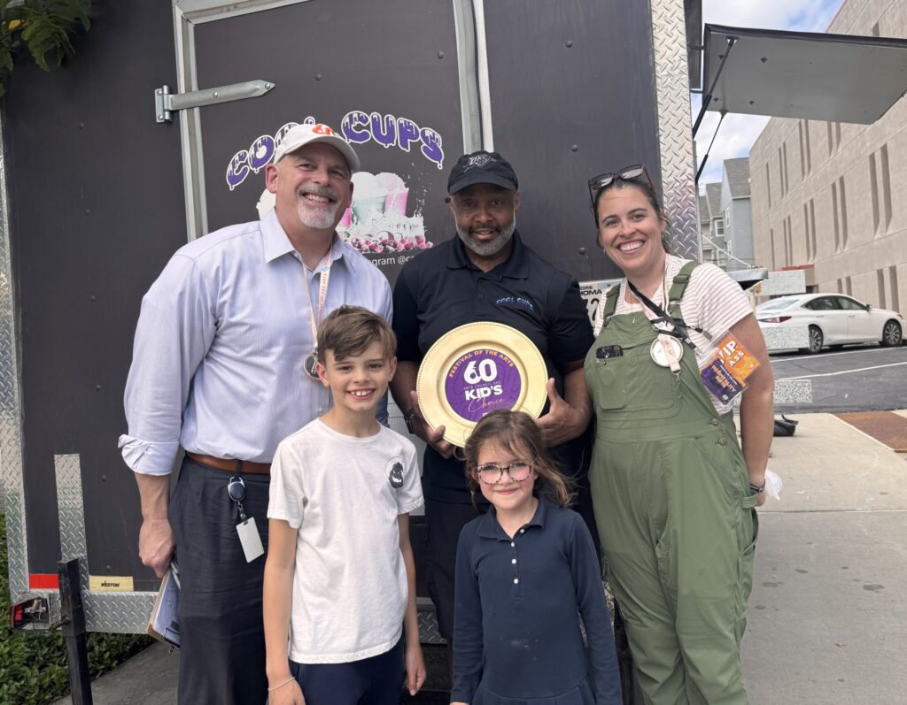 Festival food judges standing with Kids' Choice award recipient, Cool Cups.