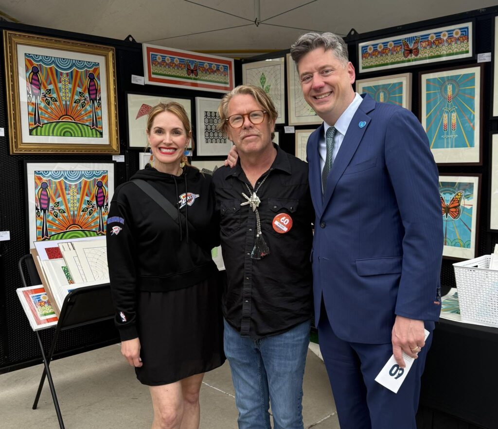 Oklahoma City Mayor David Holt standing next to Artist Rick Sinnett and Angela Cozby at the Festival of the Arts.