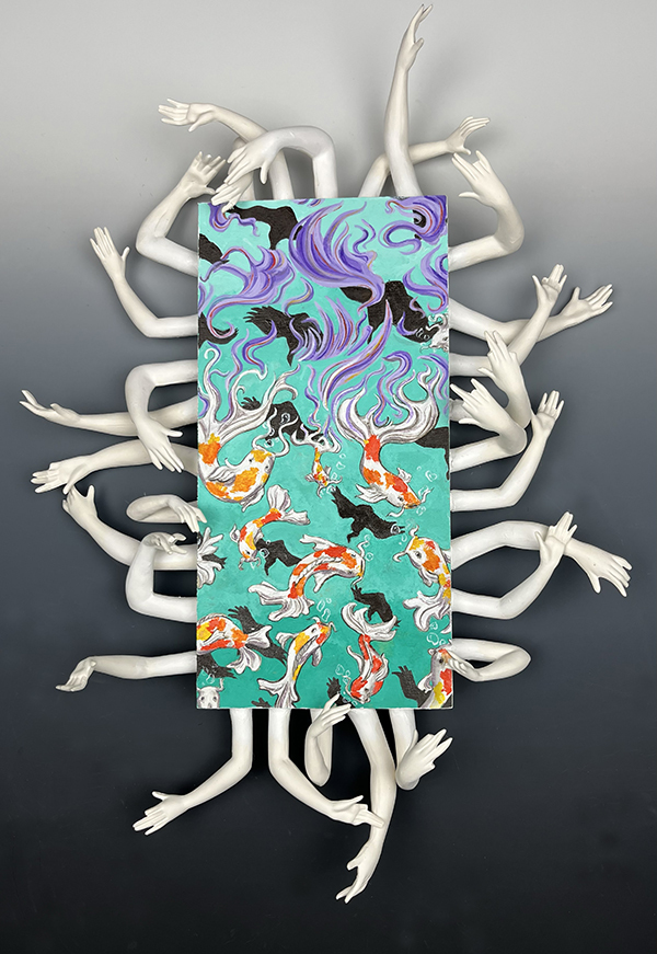 A sculpture incorporating clay, wood, and acrylic paint to form a vertical rectangle of coy swimming, framed in a wreath of stark white arms.